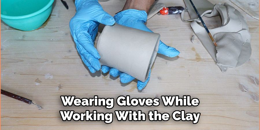 Wearing Gloves While Working With the Clay