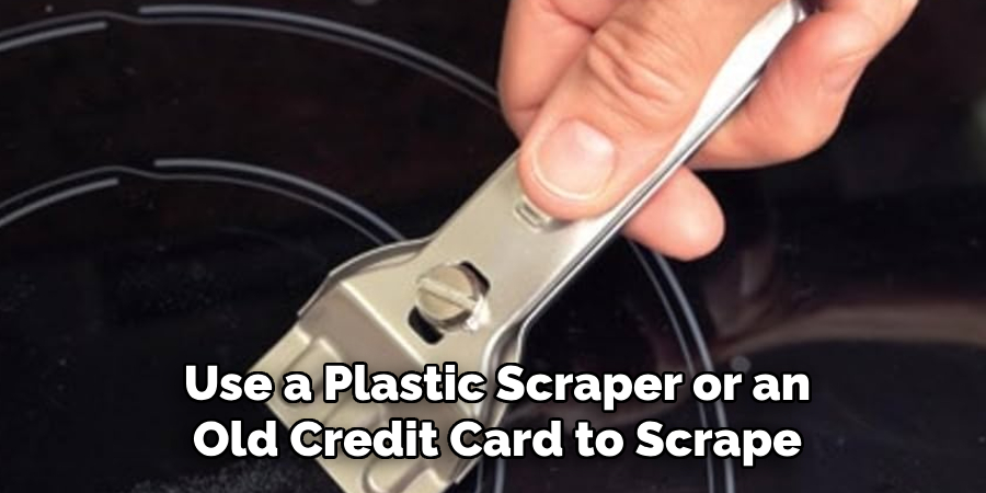 Use a Plastic Scraper or an Old Credit Card to Scrape